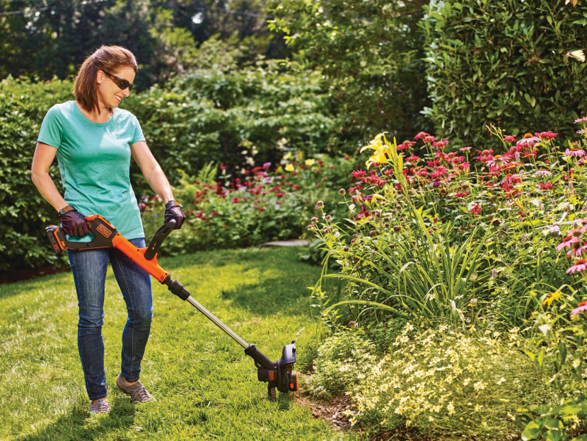 Woman using Black-and-decker string trimmer
