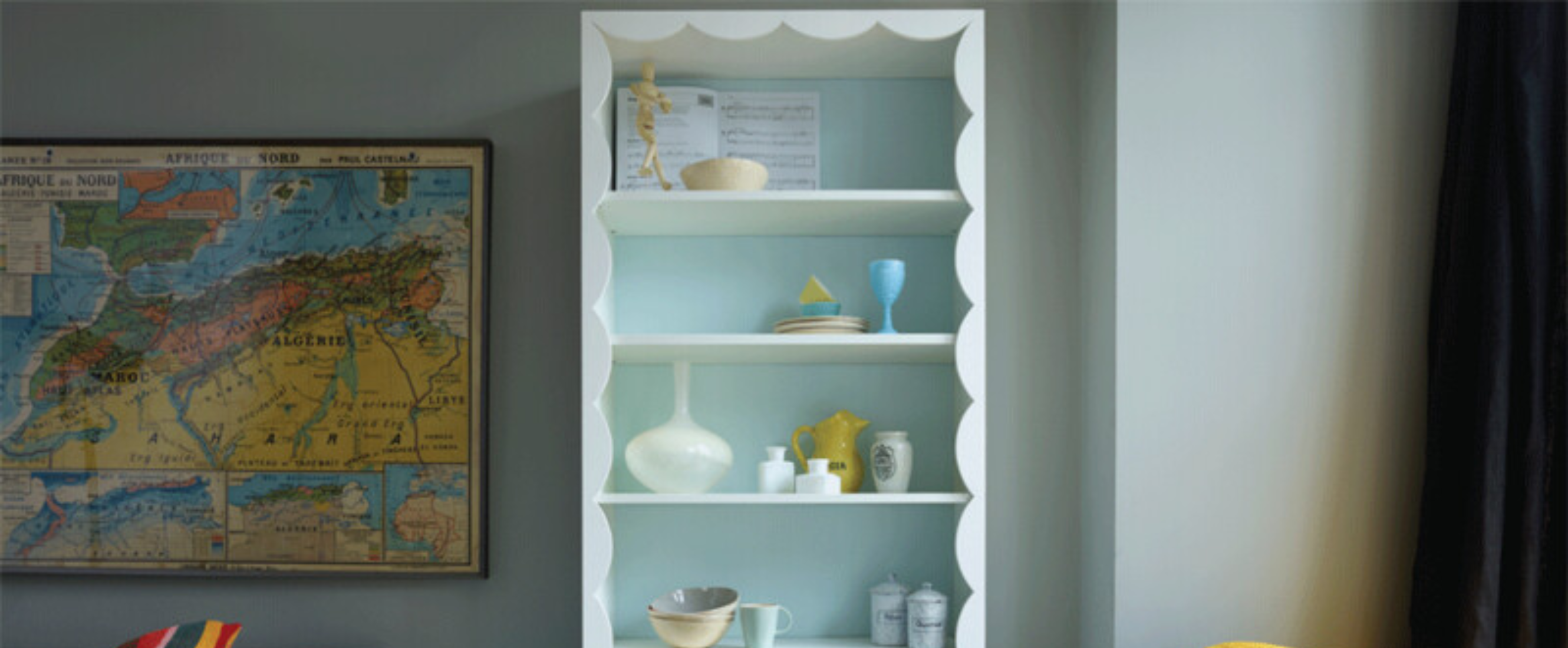 Shelf with scalloped frame against wall