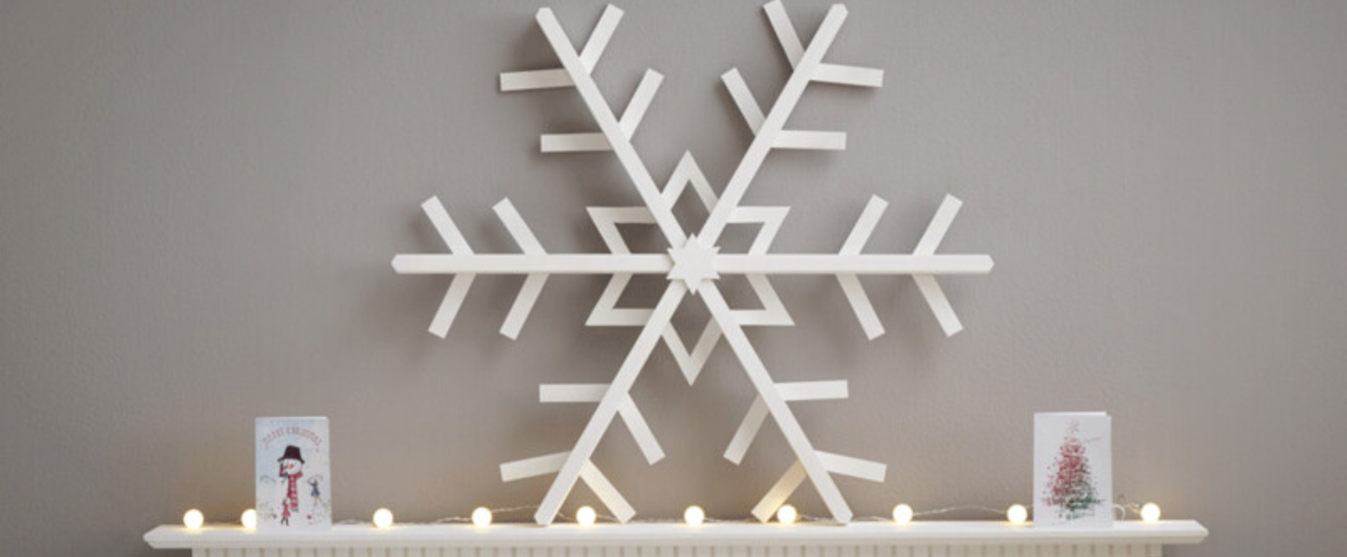 Large wooden snowflake on top of fireplace mantle