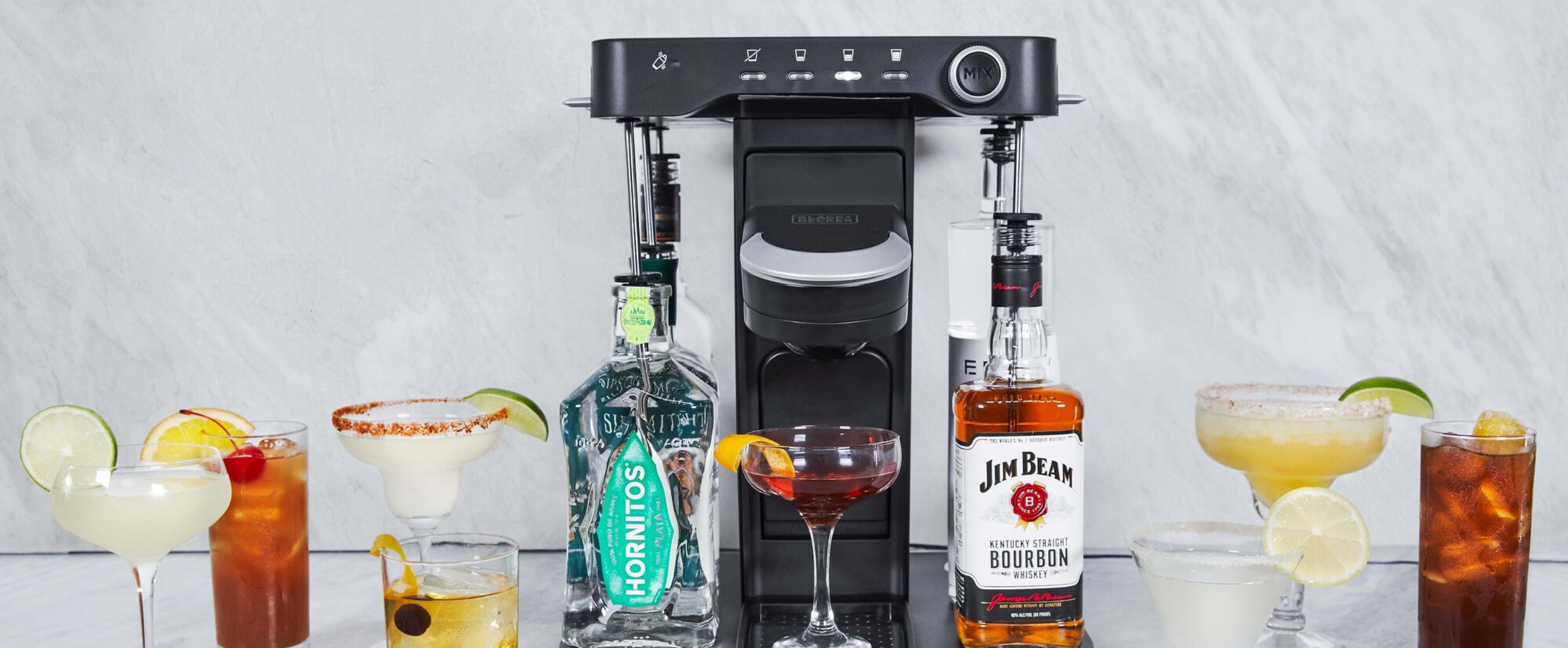 bev by Black-and-decker sitting on a marble bar with a variety of drinks