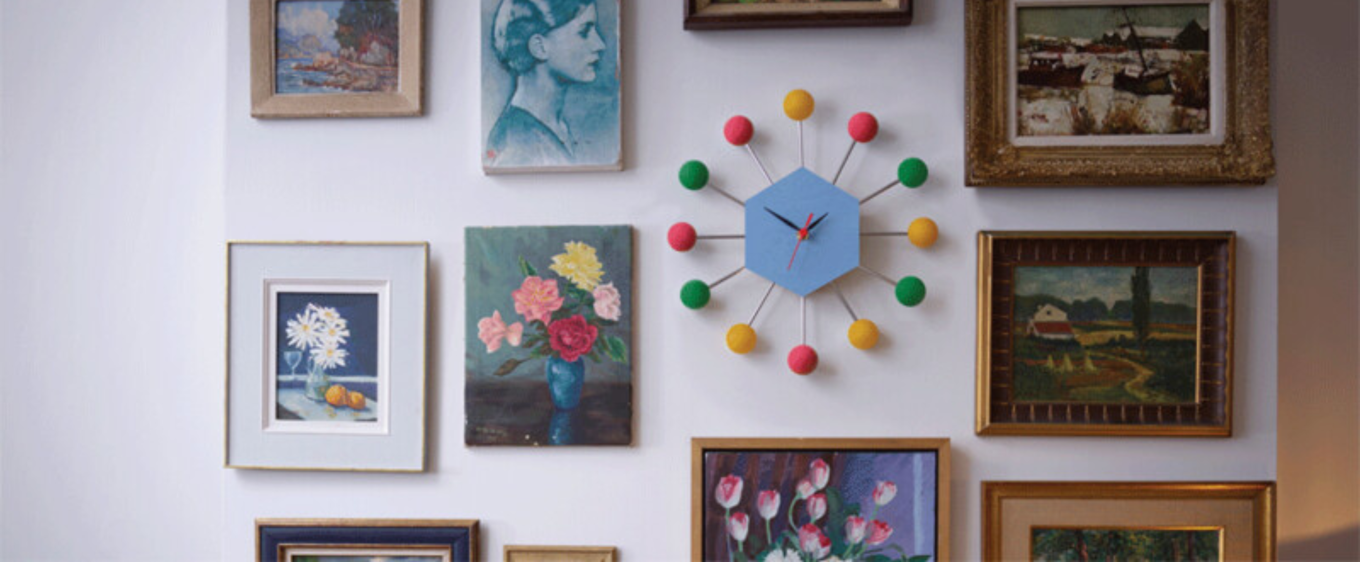 Colorful DIY clock on gallery wall with photos and art