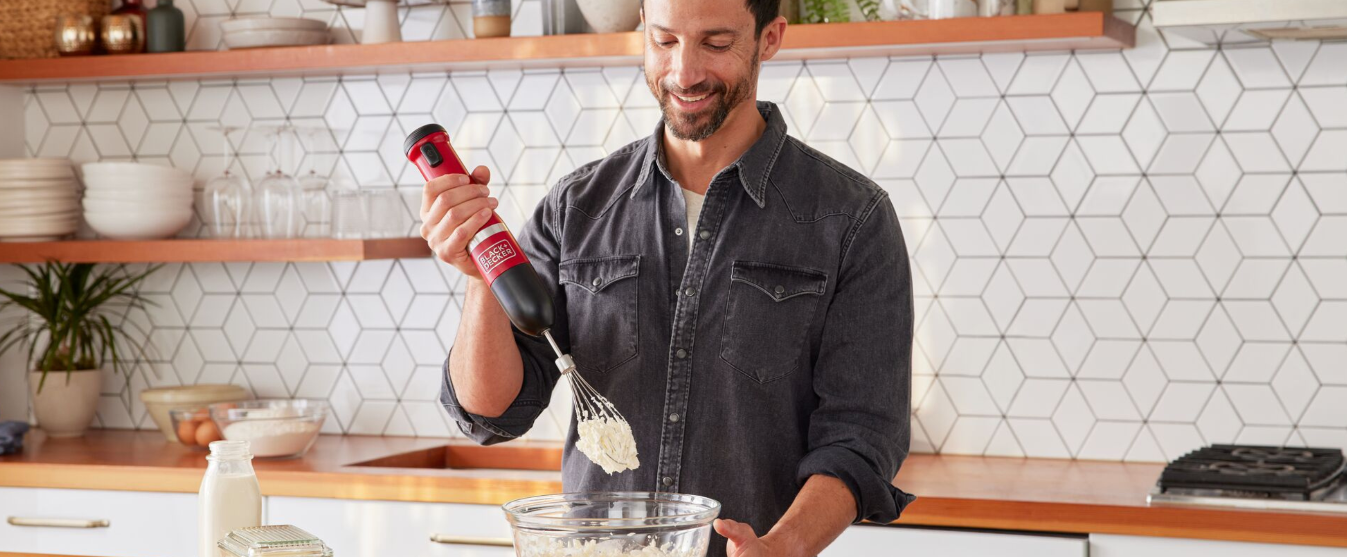 Talent using the red, Black-and-decker kitchen wand whisk to make whipped cream