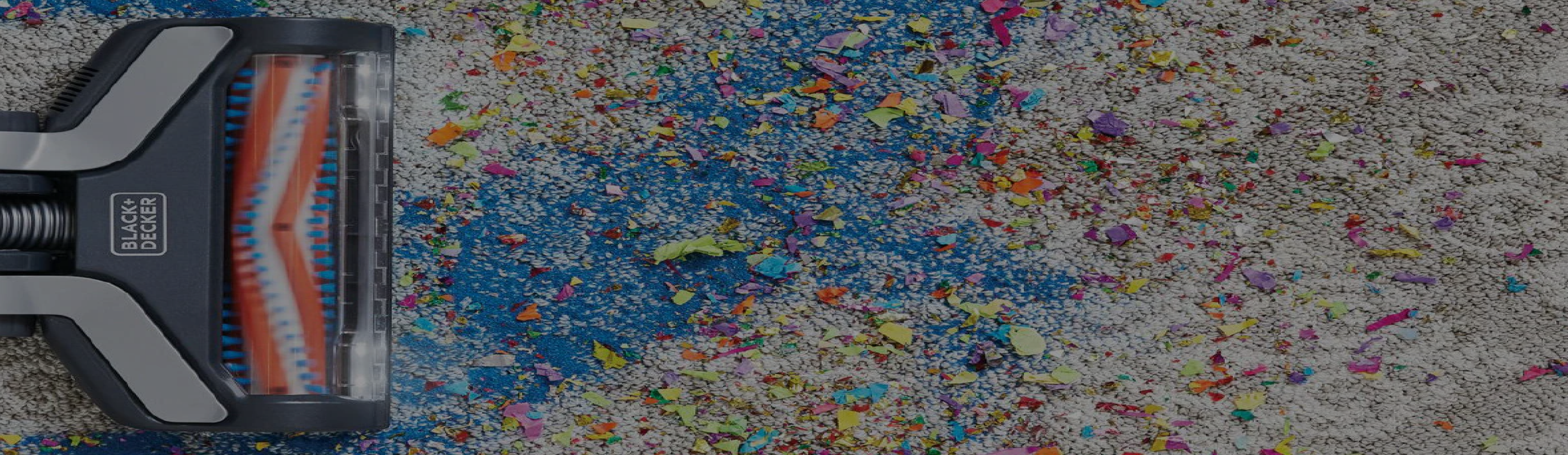 Black-and-decker stick vacuum on a multi-colored carpet
