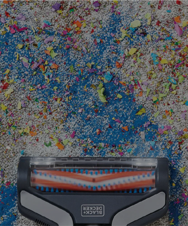 Black-and-decker stick vacuum on a multi-colored carpet