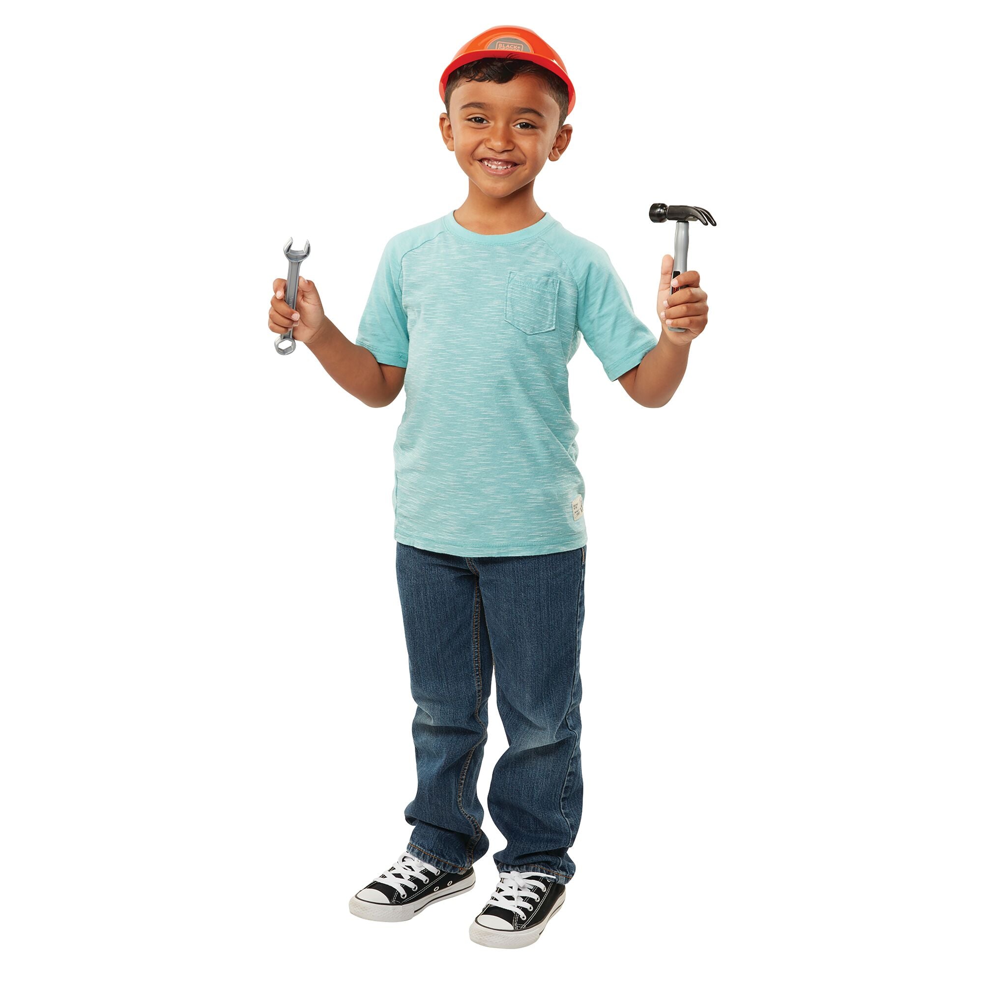 Young boy wearing Black-and-decker helmet while holding hammer and wrench toys.