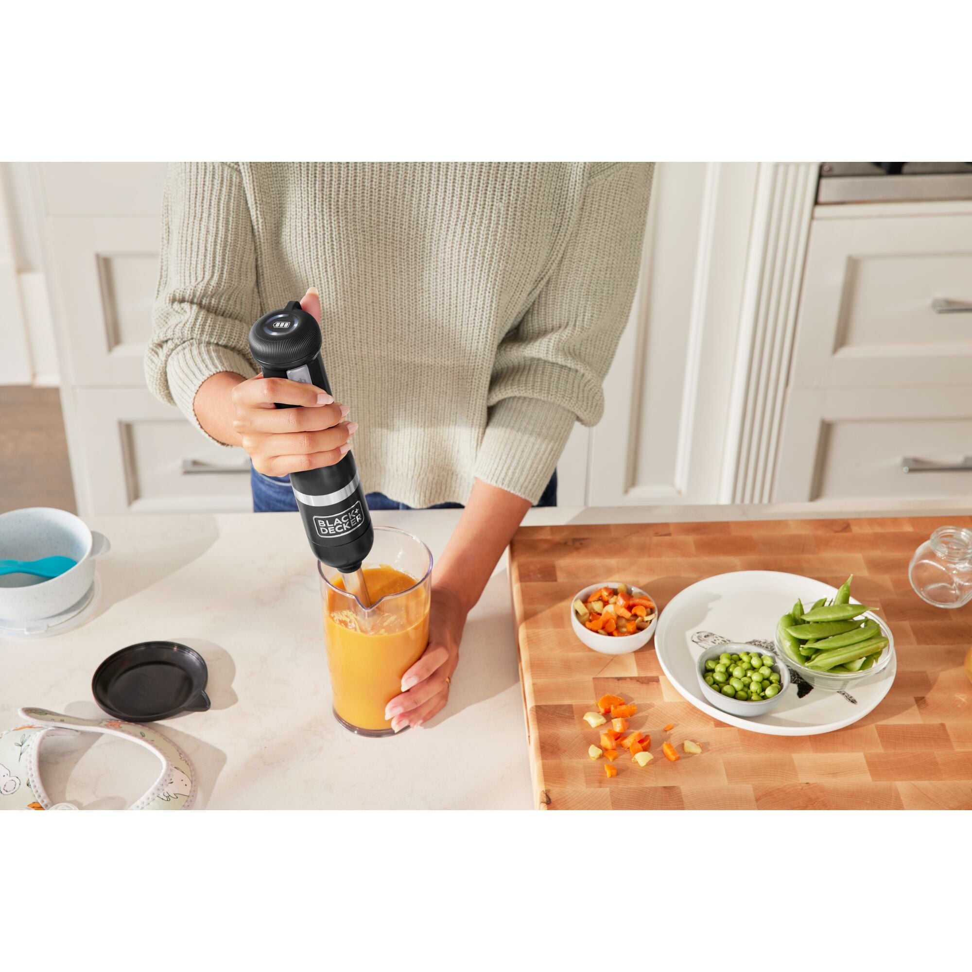 Front view of the black, Black-and-decker kitchen wand with immersion blender attached